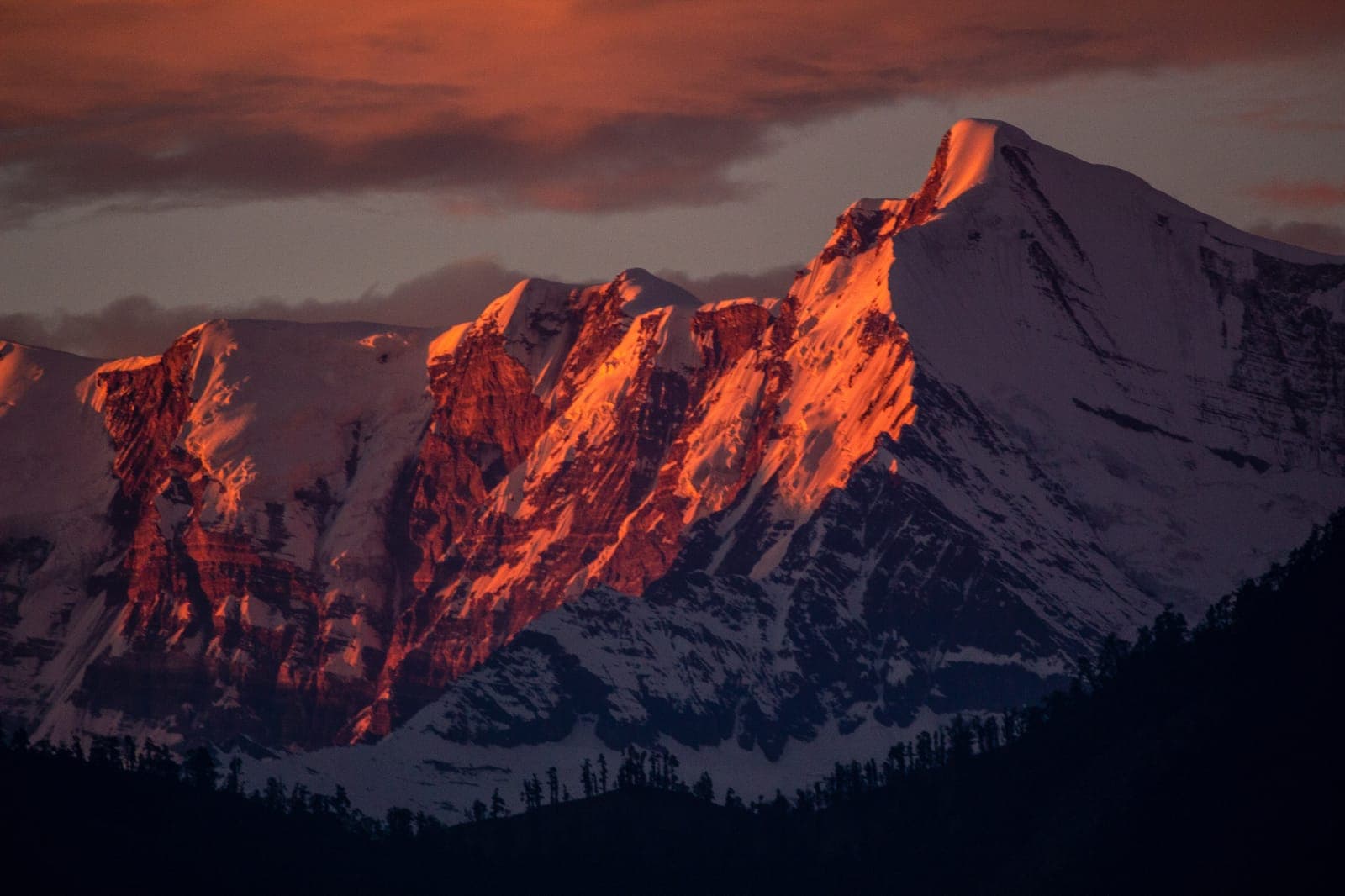 Alpenglow on snowy peaks at dawn